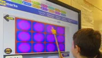 Children using an interactive whiteboard in a classroom