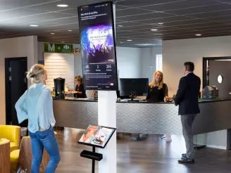 People in reception looking at display-Audio Visual-Product