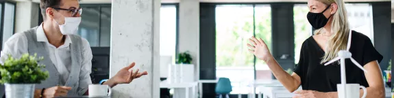 Two co-workers talking in an office