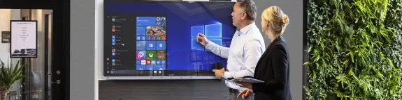 Two people using a Windows Collaboration Display 