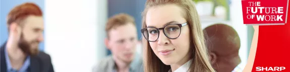 A woman stood next to a 'Future of Work' banner